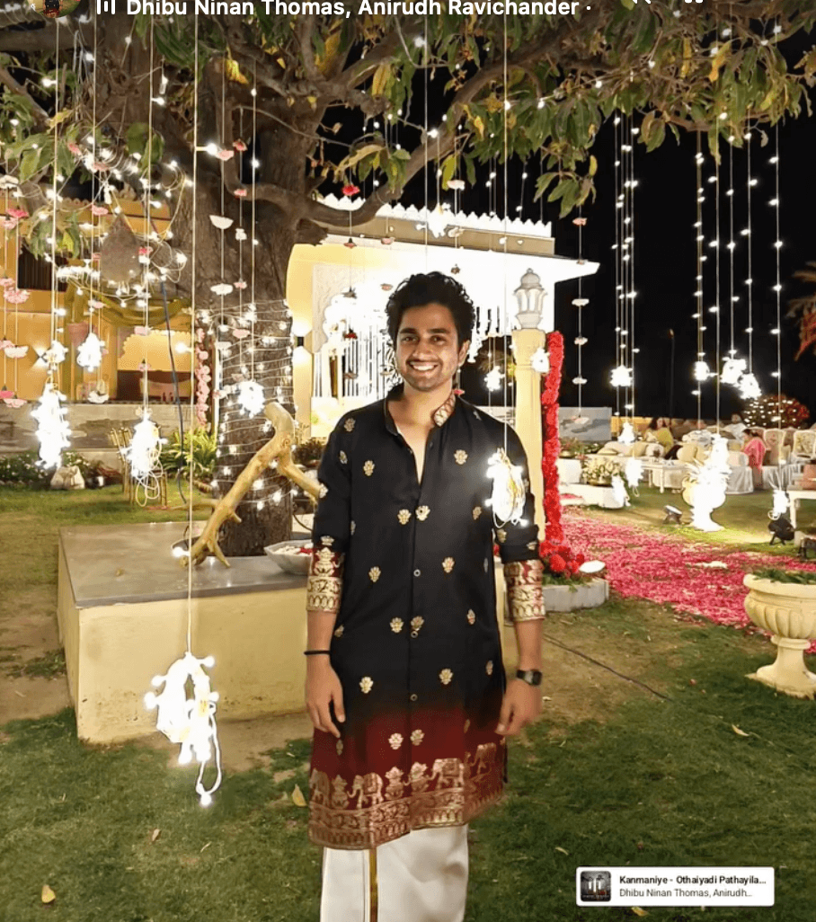 At a night event in Rajasthan, wearing a kurta under string lights